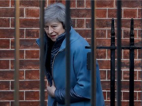 TOPSHOT - Britain's Prime Minister Theresa May leaves from the rear of 10 Downing Street in London on February 14, 2019 ahead of a vote on amendments to the Brexit withdrawal bill.