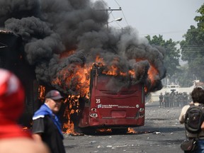 A bus burns down during a protest in the border city of Urena, Tachira, after President Nicolas Maduro's government ordered a temporary close-down of the border with Colombia on February 23, 2019.