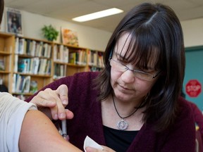 Nurse Julie Martel gives a measles an tetanus shot in 2012. In 2016-2017, 82% of Quebec primary-school children were vaccinated against the virus.