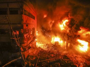 Flames rise from a fire in a densely packed shopping area in Dhaka, Bangladesh, Thursday, Feb. 21, 2019. A devastating fire raced through at least five buildings in an old part of Bangladesh's capital and killed scores of people.