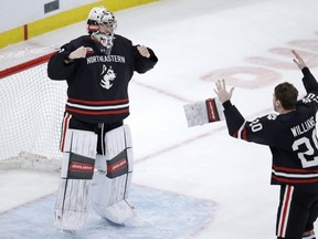 Northeastern goaltender Cayden Primeau and defenceman Eric Williams, right, celebrate after defeating Boston College 4-2 in the NCAA hockey Beanpot tournament final in Boston on Feb. 11, 2019.