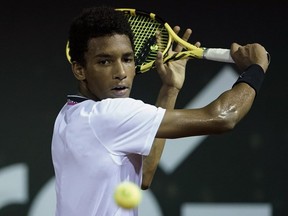 Montreal's Félix Auger-Aliassime returns the ball to Italy's Fabio Fognini at the Rio Open tennis tournament in Rio de Janeiro, Brazil, on Feb. 19, 2019.