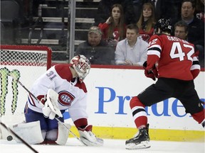 New Jersey Devils' Nathan Bastian scores his first career goal against Montreal Canadiens goaltender Carey Price on Monday, Feb. 25, 2019, in Newark, N.J.