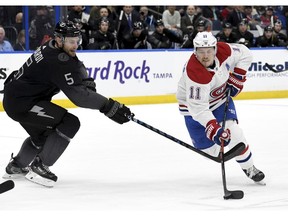 Canadiens' Brendan Gallagher (11) looks to shoot against Tampa Bay Lightning defenceman Dan Girardi on Saturday, Feb. 16, 2019, in Tampa, Fla.