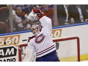 Canadiens goaltender Carey Price stretches to catch the puck flying in the air against the Florida Panthers on Sunday, Feb. 17, 2019, in Sunrise, Fla.