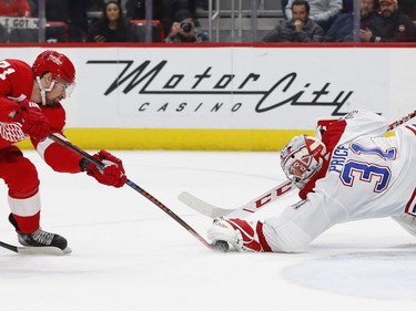 Montreal Canadiens goaltender Carey Price (31) stops a Detroit Red Wings center Dylan Larkin (71) shot in the second period of an NHL hockey game, Tuesday, Feb. 26, 2019, in Detroit.