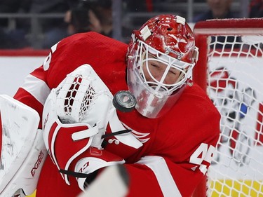 Detroit Red Wings goaltender Jonathan Bernier (45) stops a shot off his mask against the Montreal Canadiens in the third period of an NHL hockey game, Tuesday, Feb. 26, 2019, in Detroit.