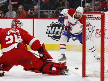 Detroit Red Wings goaltender Jimmy Howard (35) stops a Montreal Canadiens left wing Paul Byron (41) shot in the first period of an NHL hockey game, Tuesday, Feb. 26, 2019, in Detroit.