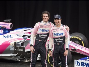 Drivers Lance Stroll, left, and Sergio Perez pose with SportPesa Racing Point F1's car at a press conference at the Canadian International AutoShow in Toronto, on Wednesday, February 13, 2019.