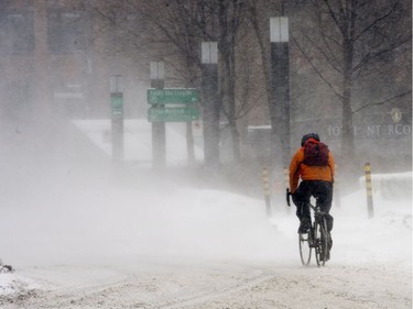 A cyclist braves the snow and -35C windchill as a winter storm hits the area Monday, February 2, 2015, in Montreal.