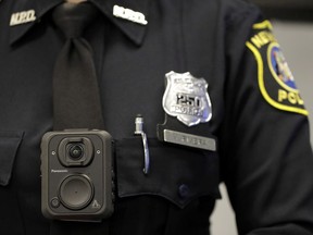 Montreal this week became the latest city in North America to decide against arming police with cameras. Newark police officer Veronica Rivera displays how a body cam is worn during a news conference unveiling the department's new cameras at the Panasonic headquarters in Newark, N.J., Wednesday, April 26, 2017.