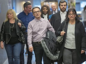 Michel Cadotte (centre) is charged with second-degree murder for suffocating his Alzheimer's-stricken wife, Jocelyne Lizotte.