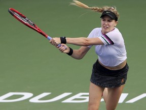 Canada's Eugenie Bouchard returns the ball to Romania's Simona Halep during a match of the Dubai Duty Free Tennis Championship in Dubai, United Arab Emirates, Tuesday, Feb. 19, 2019.