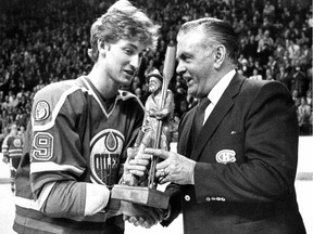 Wayne Gretzky of the Edmonton Oilers receives a wood carving from former Montreal Canadiens great Maurice Richard in Montreal on March 2, 1982.