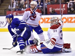 Maple Leafs' Zach Hyman and Canadiens defenceman Victor Mete battle for position in front of Montreal goaltender Carey Price in Toronto on Saturday, Feb. 23, 2019.