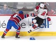 Canadiens' Jordie Benn (8) collides with New Jersey Devils' Brett Seney in Montreal on Saturday, Feb. 2, 2019.