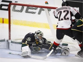 Rouyn-Noranda Huskies' Peter Abbandonato, right, has his shot grabbed by London Knights goalie Tyler Parsons during first period CHL Memorial Cup hockey action in Red Deer, Tuesday, May 24, 2016.