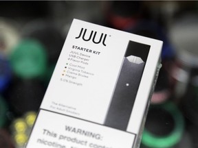 This Thursday, Dec. 20, 2018 file photo shows a Juul electronic cigarette starter kit at a smoke shop in New York. According to letters released on Friday, Feb. 8, 2019, the head of the Food and Drug Administration is questioning whether electronic cigarette maker Juul and its new partner Altria are following through on pledges to help reverse the current epidemic of underage vaping.