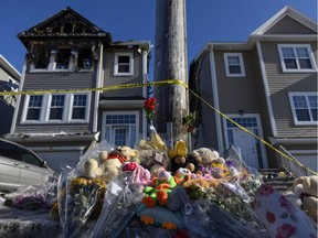 A memorial of flowers and stuffed animal toys is seen outside the scene of a fatal house fire in the Spryfield community in Halifax on Wednesday, February 20, 2019. The early-morning fire claimed the lives of seven Syrian refugee children and left the surviving mother and father in hospital.