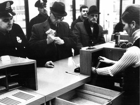 The police credit union features empty drawers. Cashier places container in a tube, which is whisked away. Photo ran with a feature published in the Montreal Gazette on Feb. 19, 1970 about precautions taken by the Montreal Policemen's Credit Union to deter hold-ups.