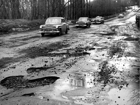 Potholes loom large in this Feb. 20, 1954 photo from our archives. The weather had been unseasonably mild.
