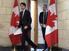 Prime Minister Justin Trudeau leaves his office with his principal secretary Gerald Butts to attend an emergency cabinet meeting on Parliament Hill in Ottawa on Tuesday, April 10, 2018. Butts has resigned amid allegations that the Prime Minister's Office interfered to prevent criminal prosecution of SNC-Lavalin.