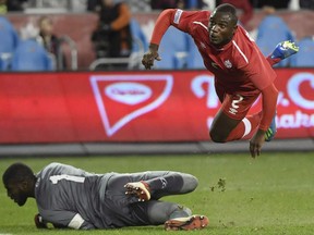Canada's Zachary Brault-Guillard gets air as Dominica's Glenson Prince (1) makes a save during second half Concacaf Nations League qualifier soccer action in Toronto on Tuesday, October 16, 2018. The Montreal Impact have acquired Canadian international Zachary Brault-Guillard after reaching a loan agreement with France's Olympique Lyonnais for the 2019 season.