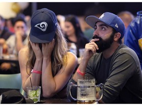Ella Silver, left, and Moe Helmy react during a viewing party for the Super Bowl 53 football game between the New England Patriots and the Los Angeles Rams in Los Angeles, Sunday, Feb. 3, 2019.
