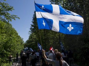 Protesters make their way down Chemin Roxham during a demonstration against illegal border crossings near St-Bernard-de-Lacolle on June 3, 2018.