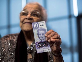 Wanda Robson, sister of Viola Desmond, holds the new $10 bank note featuring Desmond during a press conference in Halifax on Thursday, March 8, 2018. Desmond refused to accept her ouster from the whites-only section of a movie theatre in New Glasgow, N.S. in 1946.