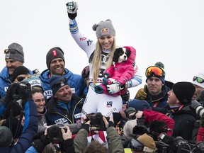 Lindsey Vonn of the United States celebrates with her dog Lucy after finishing third in the women's downhill race at the 2019 FIS Alpine Skiing World Championships in Are, Sweden Sunday, Feb. 10, 2019.