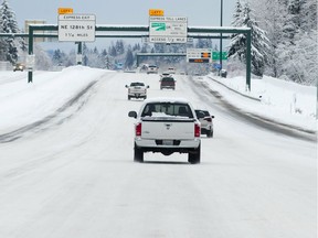 Cars drive on snow and ice on Interstate 405 approaching Kirkland, Wash., on Saturday, Feb. 9, 2019. This view looks south from Northeast 160th Street. Residents of the Pacific Northwest took to neighborhood hills with skis, sleds or even just laundry baskets Saturday to celebrate an unusual dump of snow in a region more accustomed to winter rain. (Mike Siegel/The Seattle Times via AP)