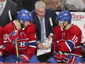 Montreal Canadiens assistant coach Dominique Ducharme talks strategy with Joel Armia, left, and Jesperi Kotkaniemi during third period against the Florida Panthers in Montreal on Jan. 15, 2019.