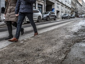 Many people find it safer to walk on the road rather than the icy sidewalks of the city right now.