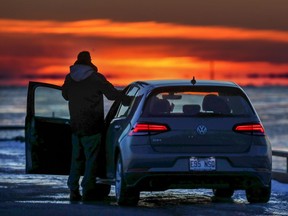 Chris Lacombe watches the sunset on the pier at 34th avenue in the Lachine borough of Montreal on Tuesday Feb. 26, 2019.