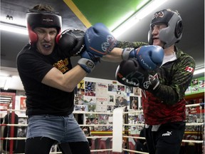 Liberal MP Marc Miller lands a blow square on the kisser of Gazette journalist Christopher Curtis Thursday morning during their charity sparring match at Hard Knox Gym. The pair raised $2,500 for the Montreal Gazette Christmas Fund.