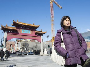 May Chiu, a member of Progressive Chinese of Quebec, next to the Chinatown gates and a new condo development project in Montreal. Chiu is calling for a moratorium on development in the area until the community can be consulted.
