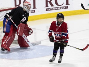 Samuel Smith, 11, who battled Hodgkin's lymphoma, takes a shot on Montreal Canadiens goaltender Carey Price as he practises with the team in Montreal, on Monday, March 11, 2019. The Children's Wish Foundation put the visit together and Smith will be on hand to watch the Habs play Detroit on Tuesday night at the Bell Centre.