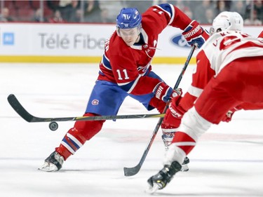 Montreal Canadiens' Brendan Gallagher has the puck knocked off his stick by Detroit Red Wings Danny DeKeyser, right, during first period of National Hockey League game in Montreal Tuesday, March 12, 2019.