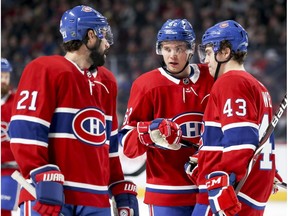 Montreal Canadiens' Nate Thompson, left, Artturi Lehkonen and Jordan Weal, right, huddle before a faceoff during first period against the Detroit Red Wings in Montreal on March 13, 2019.