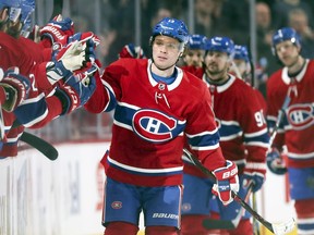 Montreal Canadiens' Max Domi gets high-fives from teammates after scoring second period goal against the Detroit Red Wings during National Hockey League game in Montreal Tuesday March 12, 2019.