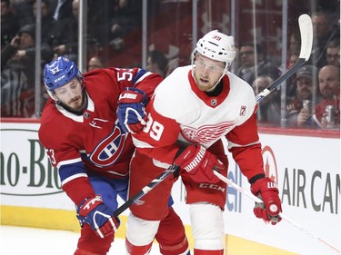 Montreal Canadiens' Victor Mete gets his stick up under the arm of Detroit Red Wings Anthony Mantha during second period of National Hockey League game in Montreal Tuesday March 12, 2019.