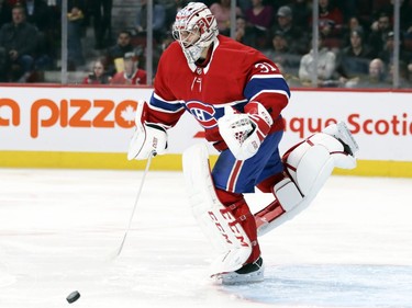 Montreal Canadiens' Carey Price makes an awkward save on Detroit Red Wing shot during second period of National Hockey League game in Montreal Tuesday March 12, 2019.
