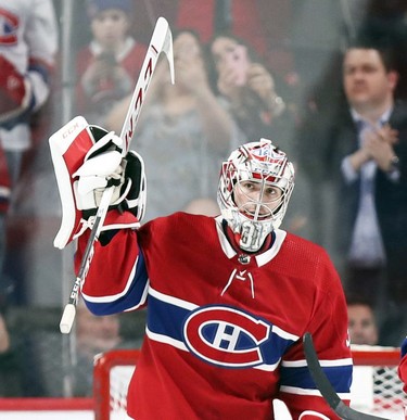 Montreal Canadiens' Carey Price waves to fans applauding his breaking Jacques Plante's record for most wins by a Habs goalie following victory over the Detroit Red Wings in National Hockey League game in Montreal Tuesday March 12, 2019.