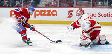 Detroit Red Wings goalie Jonathan Bernier pokes the puck away from Montreal Canadiens Tomas Tatar during first period of National Hockey League game in Montreal Tuesday March 12, 2019.