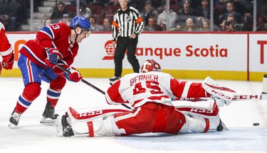 Detroit Red Wings goalie Jonathan Bernier does the splits to stop shot by Montreal Canadiens Max Domi during first period of National Hockey League game in Montreal Tuesday March 12, 2019.