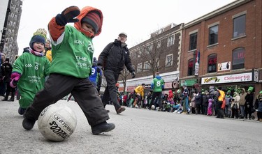 Kids play Gaelic football during the St. Patrick's Day Parade in Montreal on Sunday, March 17, 2019.