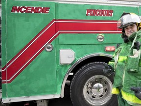 A Pincourt fireman walks with a green fire truck during the St. Patrick's Day Parade in Montreal on March 17, 2019. The off-island town has had bilingual municipality status, recognized under Quebec's French-language charter, since 1978.