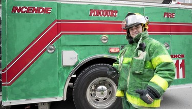 A Pincourt fireman walks with a green fire truck during the St. Patrick's Day Parade in Montreal on Sunday, March 17, 2019.