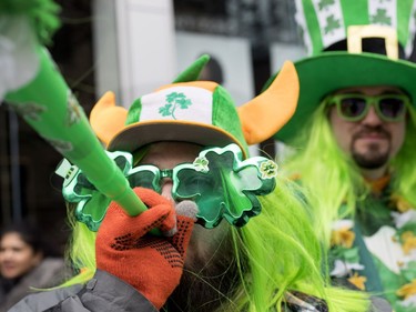 Jamie Wikan blows his horn as he takes part in the St. Patrick's Day Parade in Montreal on Sunday, March 17, 2019.